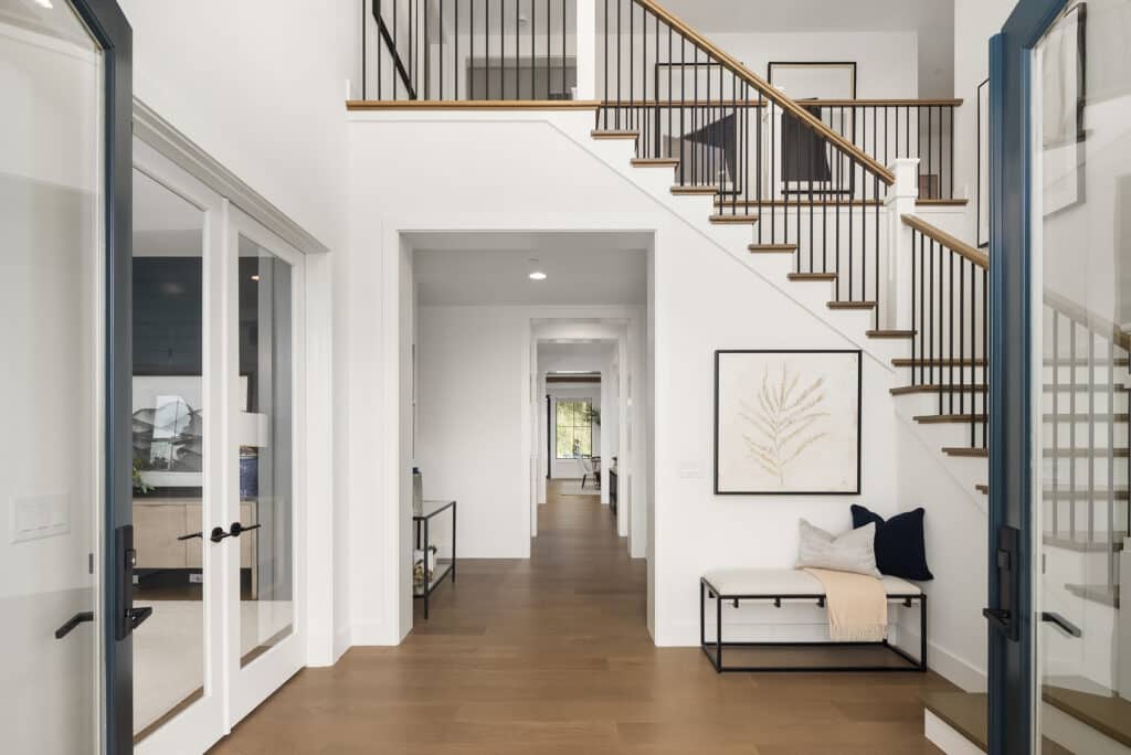 Modern house entryway with staircase and hallway.