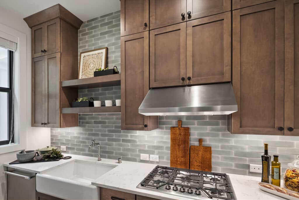 Modern kitchen with wooden cabinets and tiled backsplash.