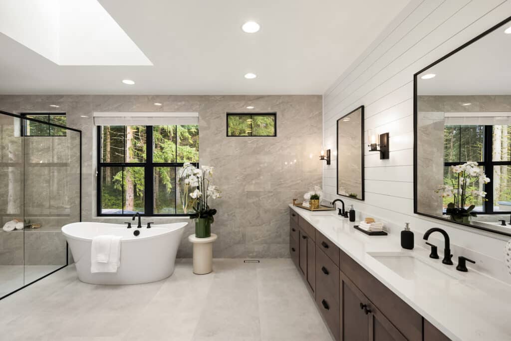 Modern bathroom with tub, shower, and double vanity.