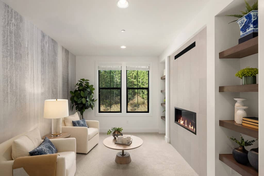 Cozy living room with fireplace and large windows.