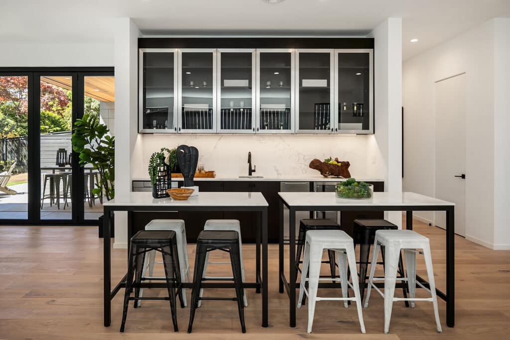 Modern kitchen with island and stools.