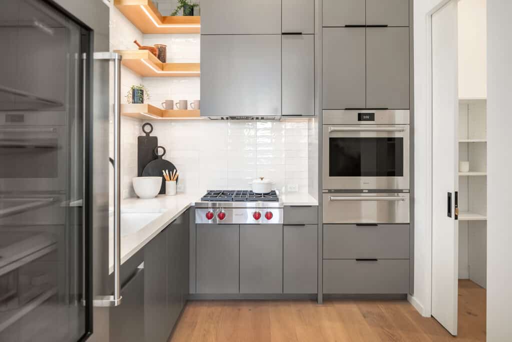 Modern kitchen with gray cabinets and open shelves.