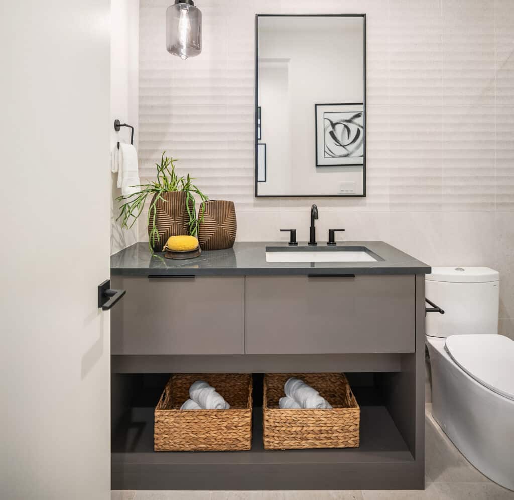 Modern bathroom with vanity mirror and wicker baskets