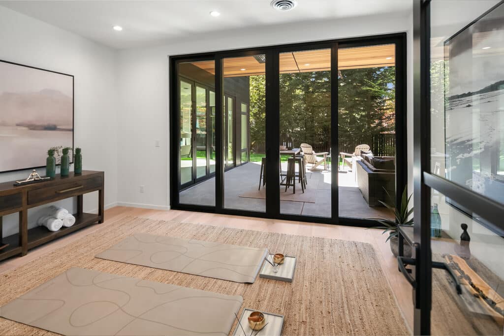 Home yoga room with large glass doors